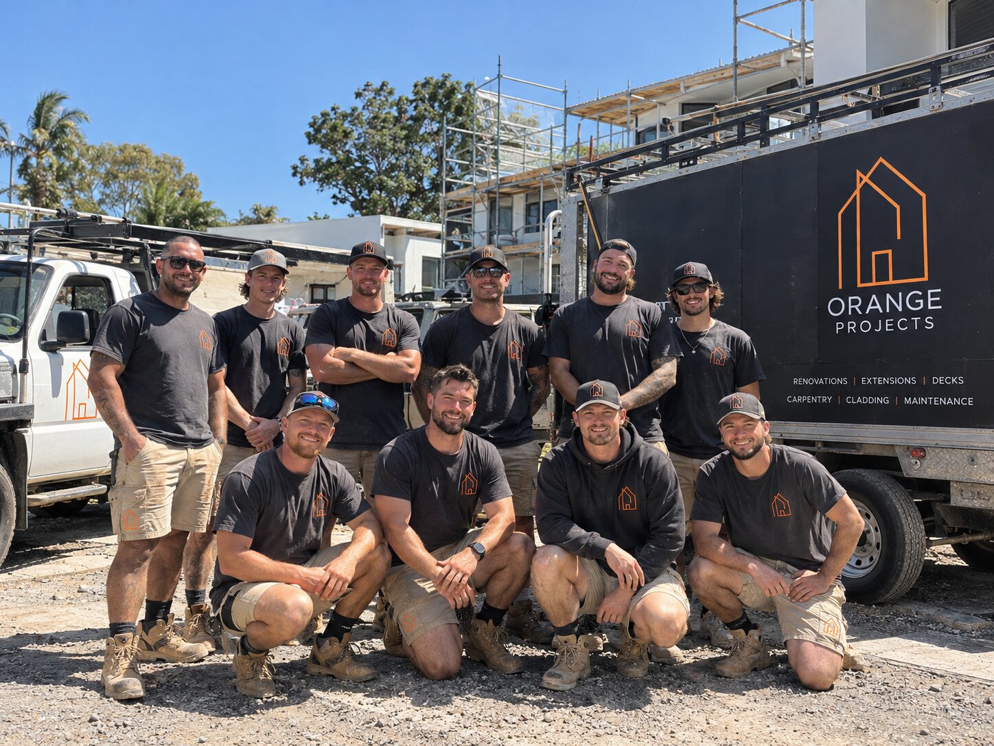 The Orange Projects team in front of their ute and trailer at a Gold Coast renovation site